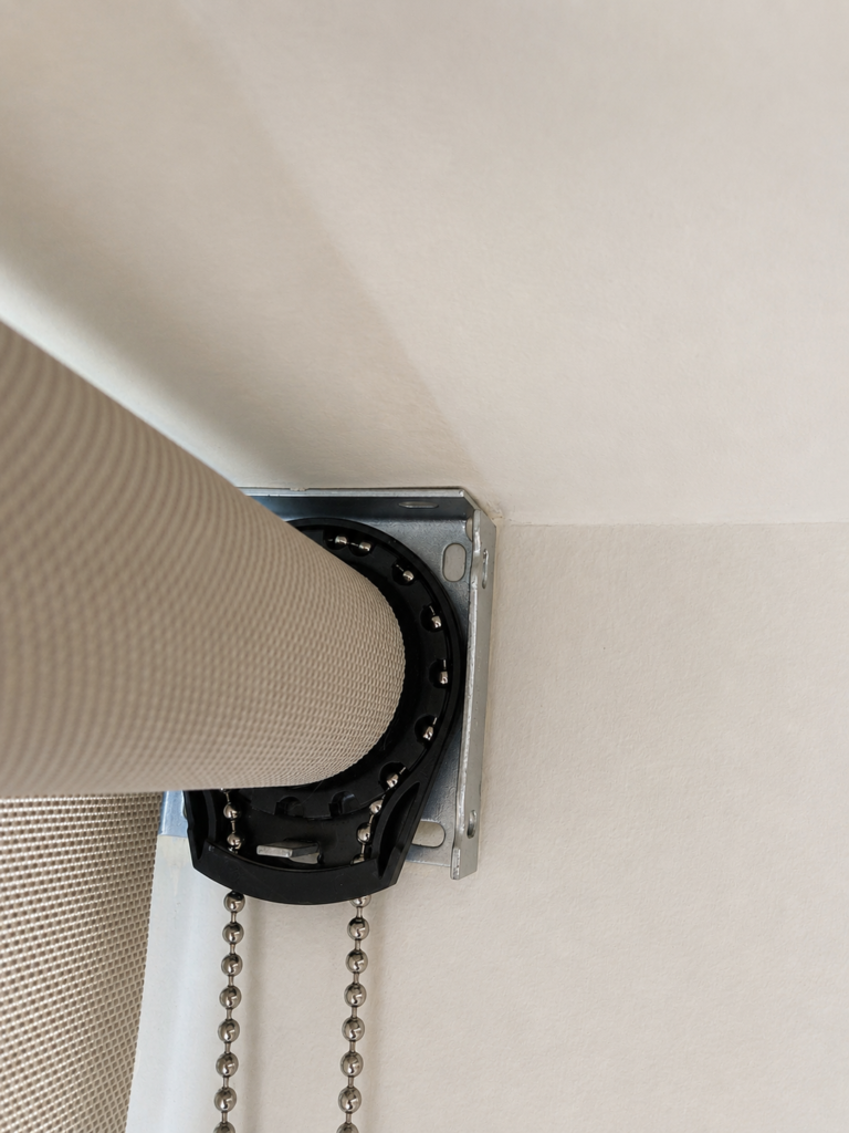 Installed roller shade bracket and chain hardware.