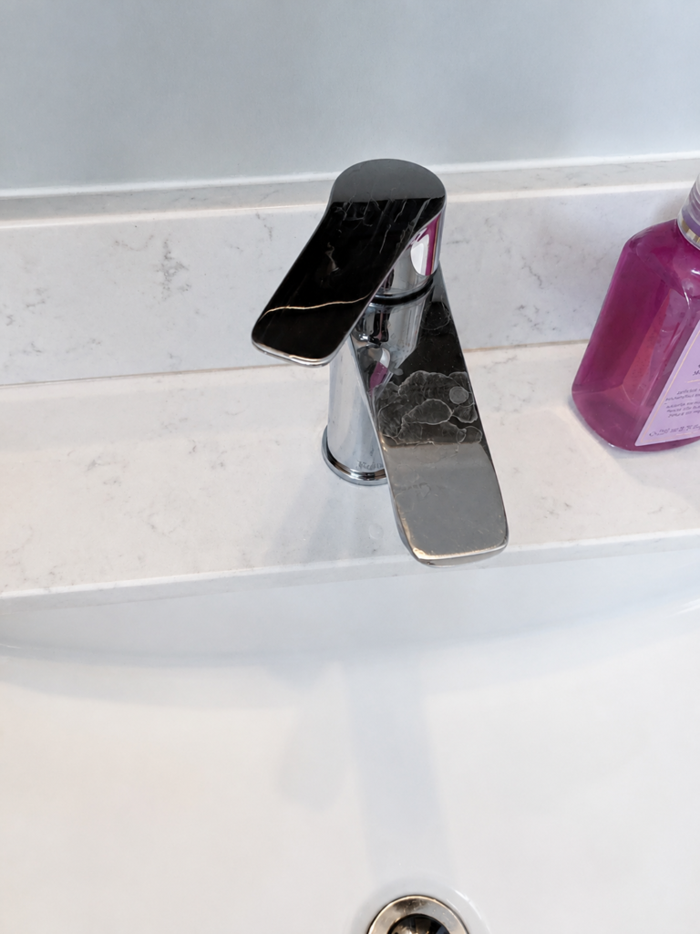Modern black bathroom faucet installed on a vanity.