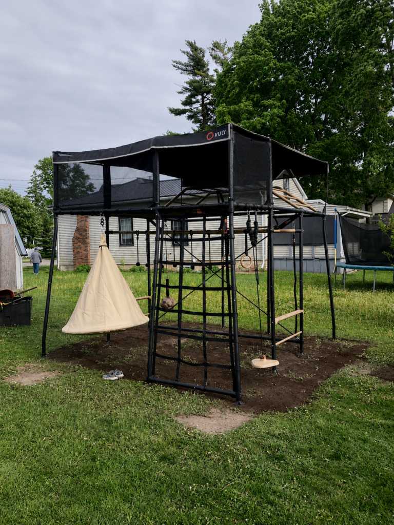 Assembled children’s outdoor playset in a yard.